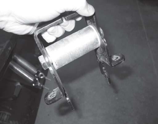 24. Insert two nylon bushings into both open ends of the roller. Press or slightly tap the bushings into the roller until they stop. See Figure 24. Nylon Bushings 25.