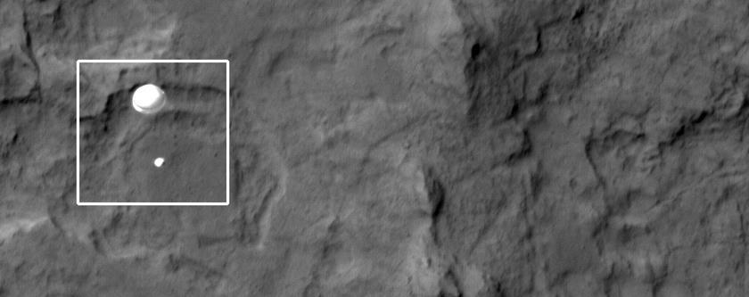 Figure 2 HiRISE image (ESP_028256_9022) of Curiosity descending to the Martian surface acquired August 5, 2012. Image Source: http://hirise.lpl.arizona.edu/releases/msl-descent.