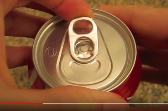 Why when you open a can of coke, bubbles come
