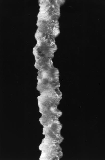 POLYMER MELT EMERGING FROM A CAPILLARY TUBE description of hard turbulence, a power-law distribution in length scales is produced by this handing off of energy from