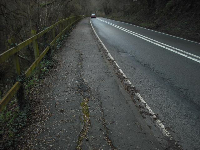 Near Old Station Tintern A466 View looking South The image shows a typical failure of the carriageway footpath