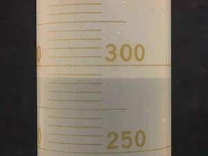 In some plastic cylinders water has a flat surface.
