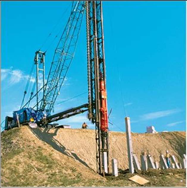 APPLICATIONS (continued) This large crane-mounted hammer is used to drive piles into the ground.