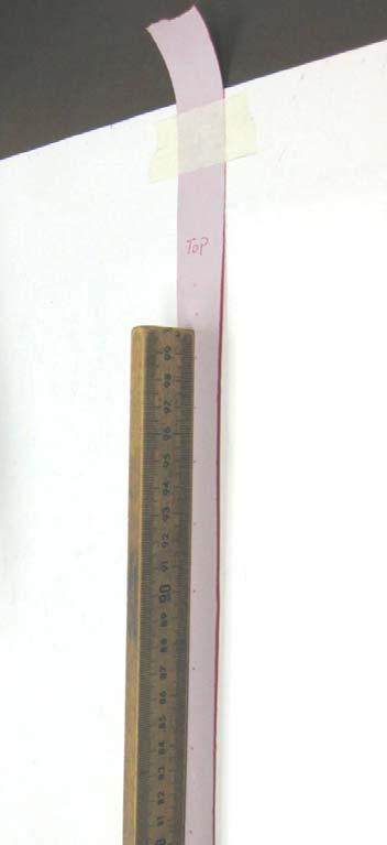 5. After you have performed the experiment, remove the tape from the apparatus and place it on a table with a ruler as shown in Figure 3. Fasten the tape to the table using sticky tape.