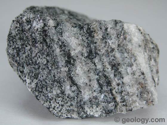 Foliated - contain aligned grains of flat minerals Gneiss is foliated metamorphic rock that has a banded