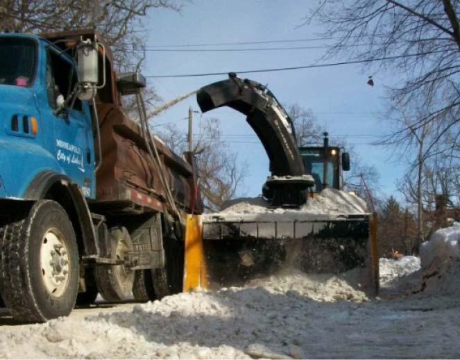 Snow removal using trucks and loader with blower Loader with reversible front plow,