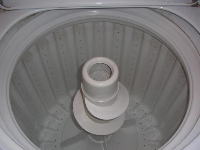 19. In a washing machine, during the spin cycle, the clothes are pressed against the inside of the vertical wall of a rotating drum 0.35 m in radius that has a period of 0.25 s about a vertical axis.