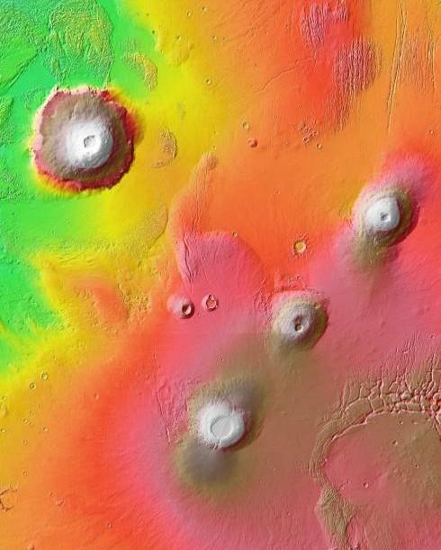 The Tharsis region of Mars is located along the equator near the western terminus of the Valles Marineris. It is a large upland formed by mostly volcanic processes.