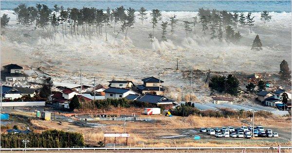 with it. The tsunami, seen crashing into homes in Natori, Miyagi prefecture.