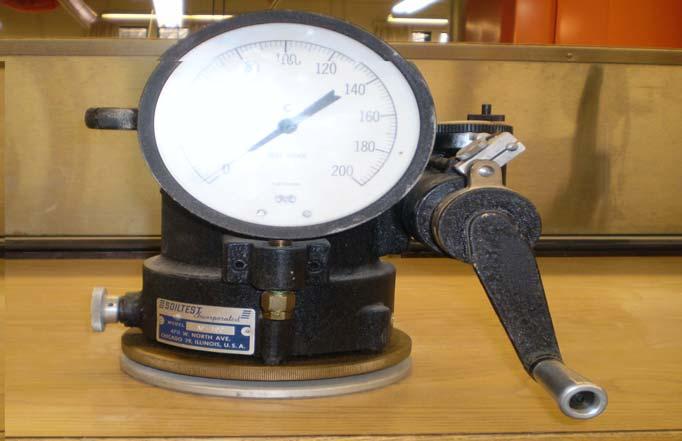 Figure 2.7 Hveem Stabilometer Hveem stabilometer test is a closed-system triaxial test which involves the application of an increasing load to the top of the sample at a predetermined rate.
