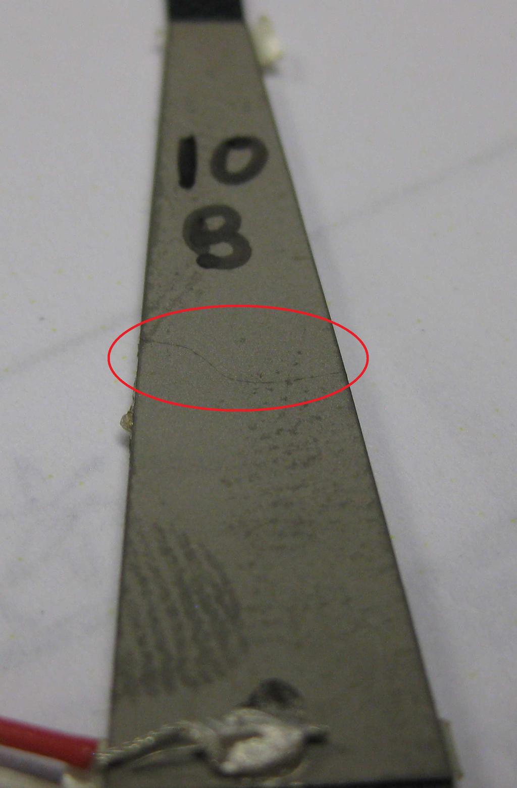 Figure 4.26: Fractured piezoelectric layer. to bond and began to peel off. This bonding failure has also occurred for entire actuators.