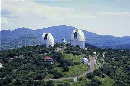 There are two large domes on Mt. Locke (foreground). On the left is Struve 2.1-meter telescope dome, and on the right is the Harlan J. Smith 2.7-meter telescope dome.