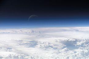 Atmosphere Atmosphere- a thin layer of air that forms a protective covering around the planet. If Earth had no atmosphere, days would be extremely hot and nights would be extremely cold.