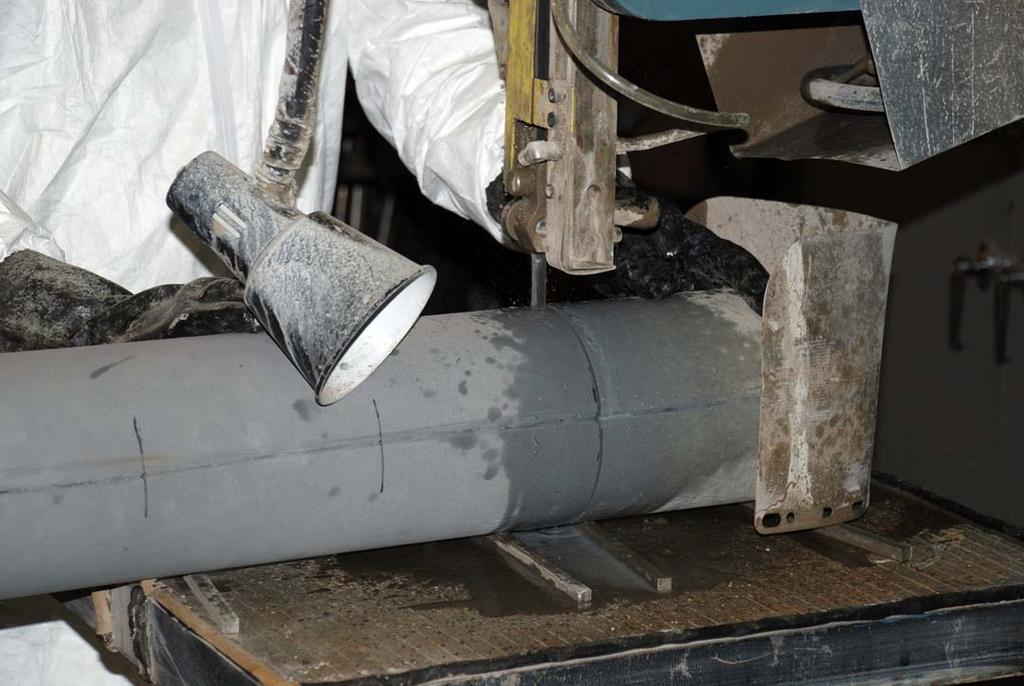 Figure 3. Gamma Guard II and Portland cement column sample being cut into sections. The bulk density values for the Gamma Guard I Portland cement samples ranged from 2.10 to 2.