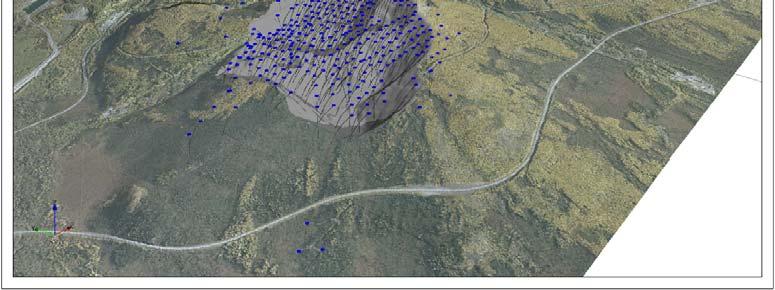 Blue markers indicate the location of the exploration borehole collars, with the black lines showing the surveyed borehole traces.