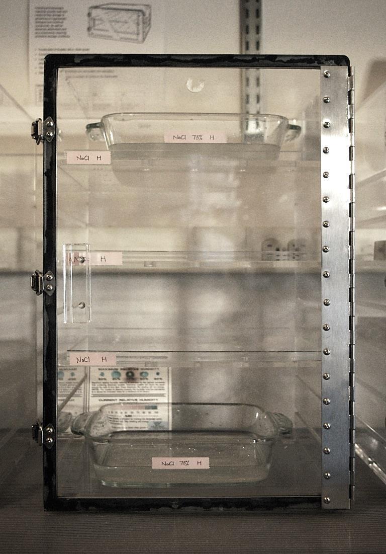 Figure 4.5 Desiccator of fixed RH established by saturated salt solutions placed in the pans at the bottom and top self of the cabinet.