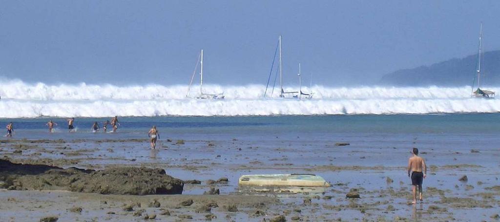 Figure 2: The tsunami of 26 December, 2004, approaching Hat Ray Leah beach on the Krabi coast, Thailand [1]. coast of Thailand with a wave of depression at the front.