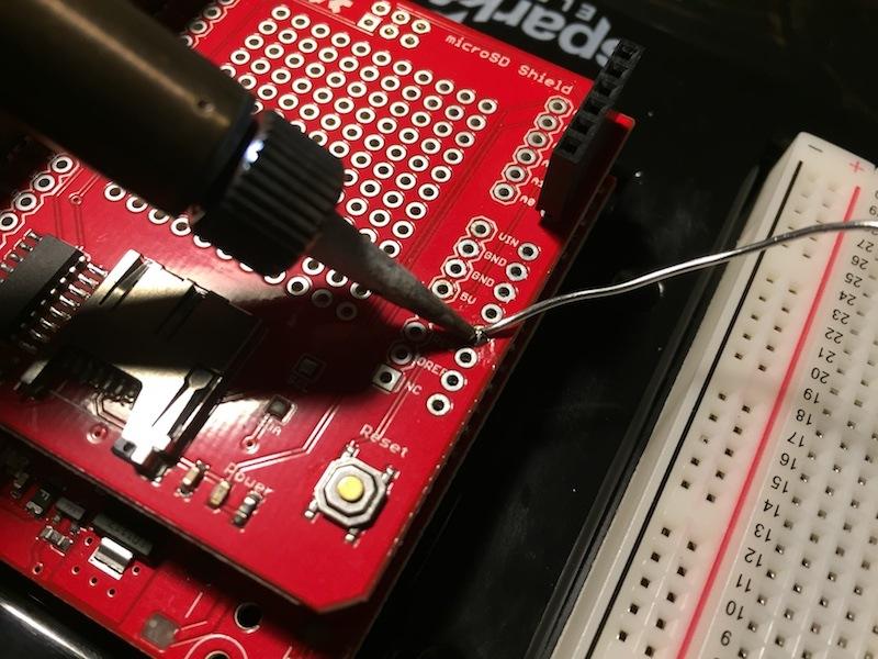 Figure 20: Soldering on a wire to the microsd Shield 4.
