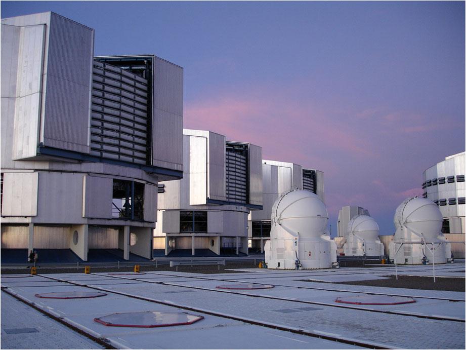 Fig. 1 The Very Large Telescope observatory features four 8.2 m unit telescopes, four 1.8 m auxiliary telescopes, and the infrastructure for performing optical interferometry. Image Credit: S.