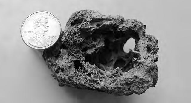 HOW ARE IGNEOUS ROCKS CLASSIFIED? 121 Figure 5-4 Scoria is an igneous rock that contains large air pockets.