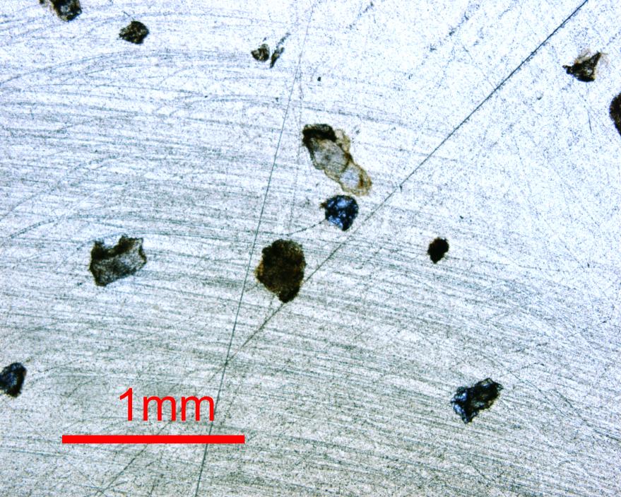 Figure 2. Sericite grains mounted in epoxy on a thin section under plane polarized light and cross polarized light. Results δ18o isotope values ranged from 40.49-50.