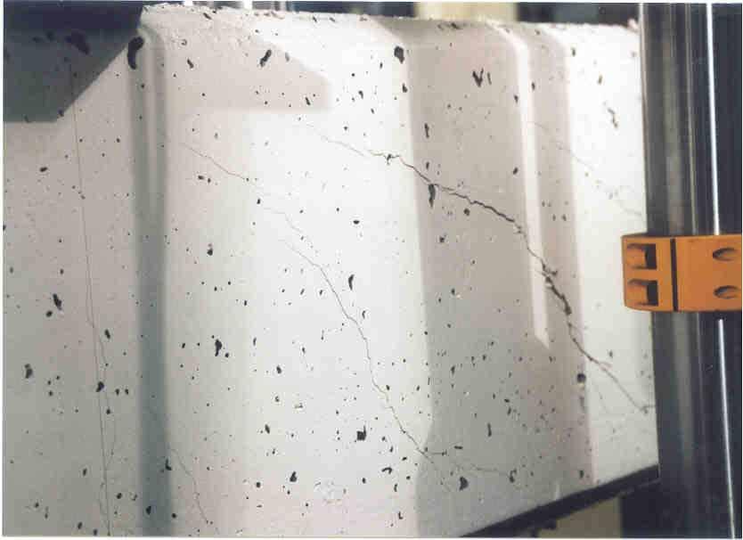 Chapter 4 cracks developed. At failure, the compressed top part of the beam was crushed due to the combination of compressive and shear stresses. In the photographs in Figure 4.