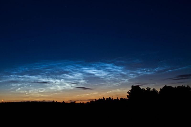 FIGURE 9.9 Although the mesosphere has extremely low pressure, it occasionally has clouds. The clouds in the photo are mesopheric clouds called noctilucent clouds.