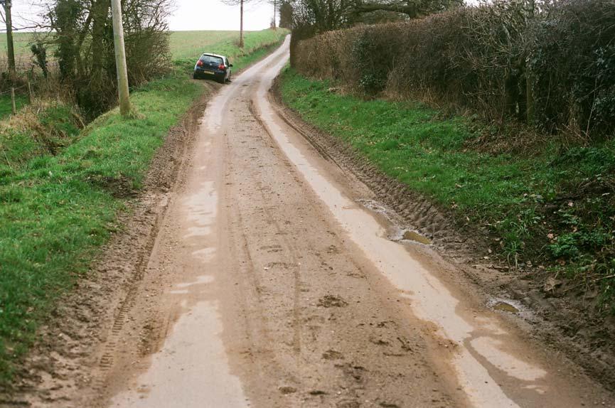 50. Damaged roadside verges and soil on road,