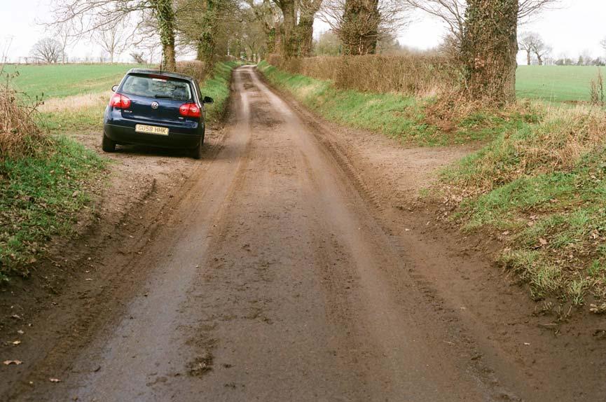 44. Damaged roadside verges and soil on road,