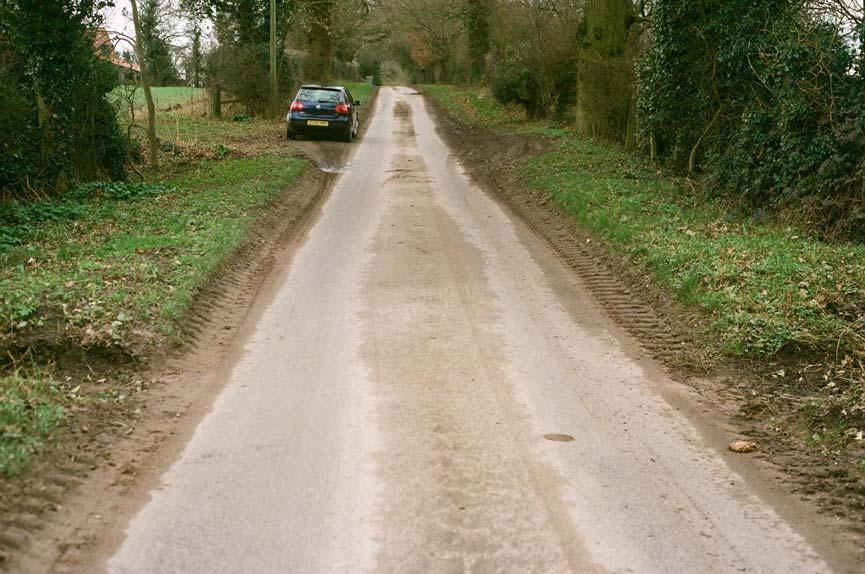48. Damaged roadside verges and soil on road,
