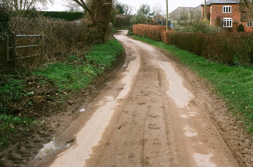 Damaged roadside verges and soil on road,