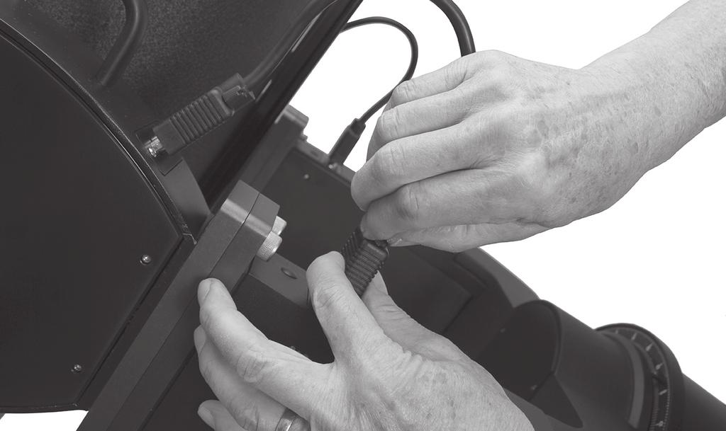 Line up the thumbscrew into the groove in the microfocuser. Slide the 1.25" diagonal prism into the adapter (D).
