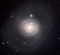 M74 At a distance of 32 million lightyears in the constellation Pisces, M74 is home to about 100 billion stars. It is the archetypical example of a grand design spiral galaxy.