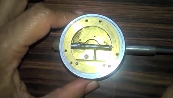 Now we can see the dial indicator back cover is opened and pressing the plunger we can see the movement of a plunger.
