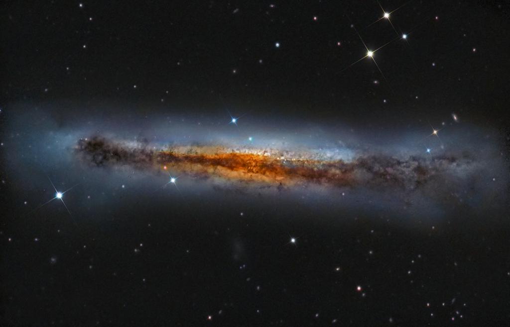 Dusty NGC 3628: a galaxy viewed edge-on Stars in our own Milky Way (white, isolated dots) Starlight in