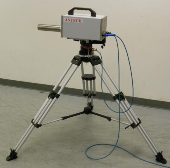 photograph of the RadSearch detector head and pan and tilt unit mounted on a tripod for measurement. Figure 1. RadSearch detector head and pan and tilt unit mounted on a tripod for measurement. The collimator barrel is fitted.