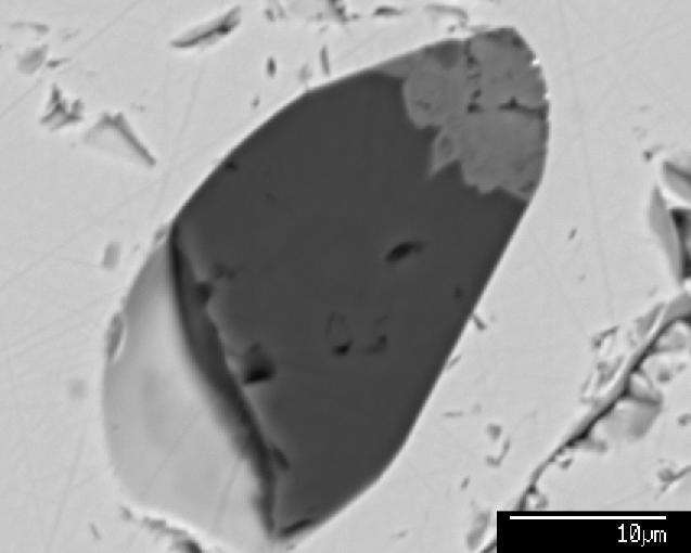 The lower image, from NWA 6926, shows a melt inclusion within Cr-spinel (near-white).