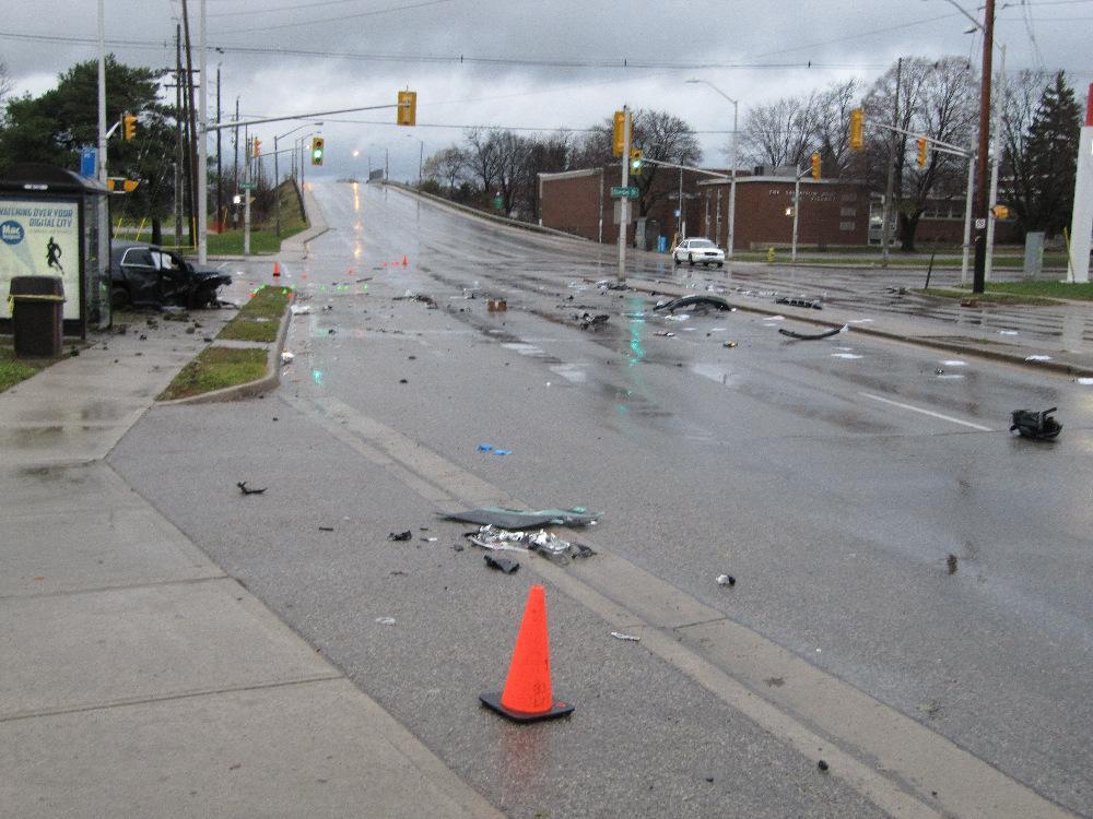 View, looking north, from just south of the intersection of Highbury and Dundas showing the debris field from the Porsche collision The photo below