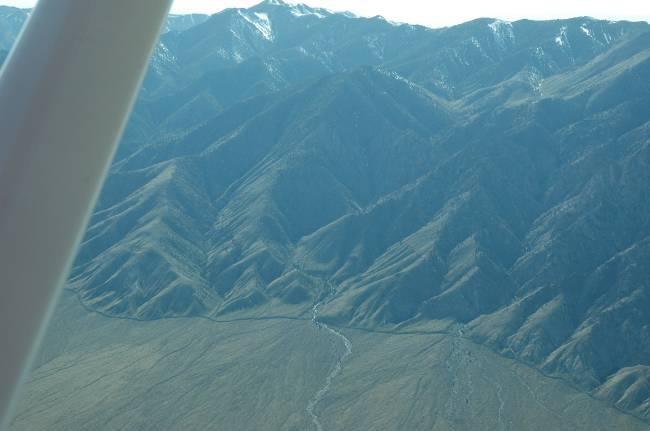 An aerial tour of the valley on April 21, 2009 revealed flow in most channels up-gradient of the mountain front/alluvial fan interface which also coincides with many of the faults, including the