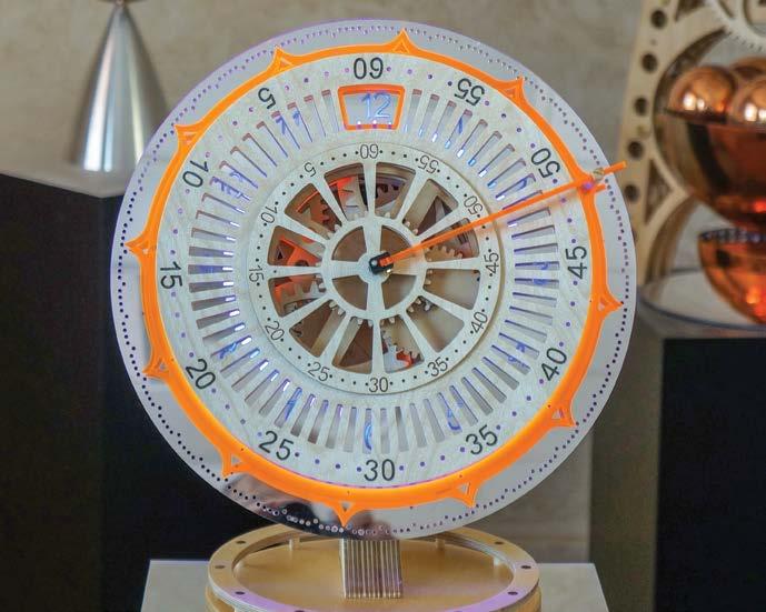 have been inserted as well as the intermediate dial gearing. In Figure 14 we slide on the numbers dial ring and attach the hour indicator. All that is left is to add the planetary minutes wheel.