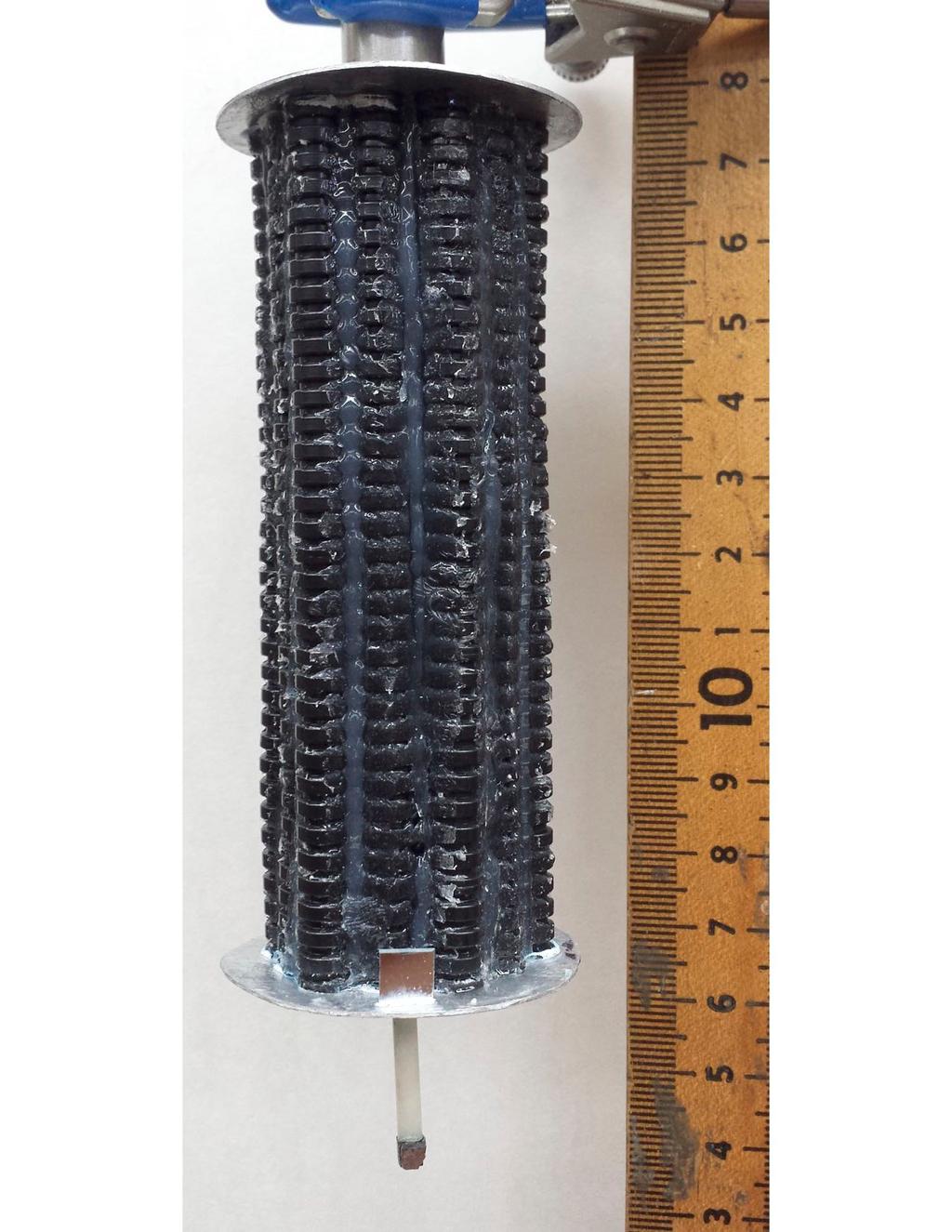 (a) (b) Figure 2: (a) Largest specimen of aligned corrugated tubing and silicone rubber matrix composite. (b) Cross section of largest sample. diameter of an individual corrugated tube.