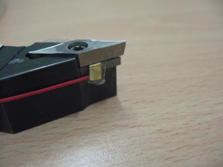 Cutting insert 10mm Piezoelectric film 10mm Tape Metal shim Spacer Integral sensing unit Piezoelectric film Cutting insert Spacer (a) (b) (c) Figure 1- (a) Components of smart cutting tool; (b)