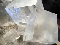 This regular arrangement gives the sodium chloride crystal its characteristic cubic shape. You can see this distinctive crystal shape when you look at table salt crystals through a magnifying glass.