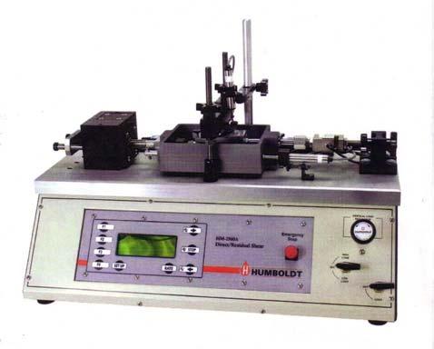 (0.0001 to 0.40 in/min). Figure 2.6 shows a picture of the pneumatic shear device with shear box assembly held between the motor (left) and load cell (right). FIGURE 2.