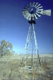 The kinetic energy of wind can turn the blades of a windmill.