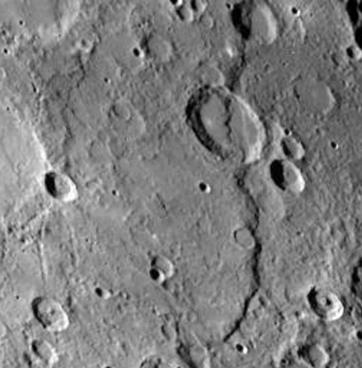 FIGURE 9.24 Discovery Scarp on Mercury. This long cliff, nearly 1 kilometer high and more than 100 kilometers long, cuts across several craters.