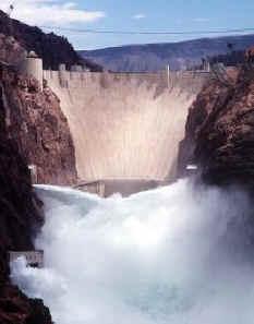 Gravitational energy Water falling down to the generators at the base of the dam accelerates to 80 mph.