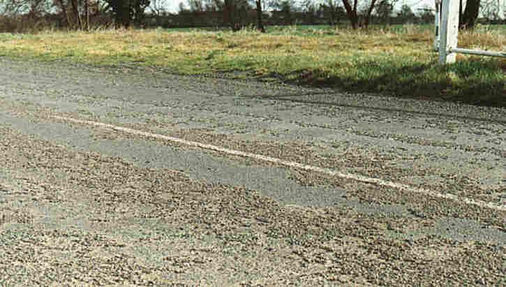 Stripping of stone chippings from surface of road