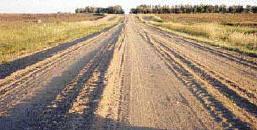 material) Rutted gravel road constructed from