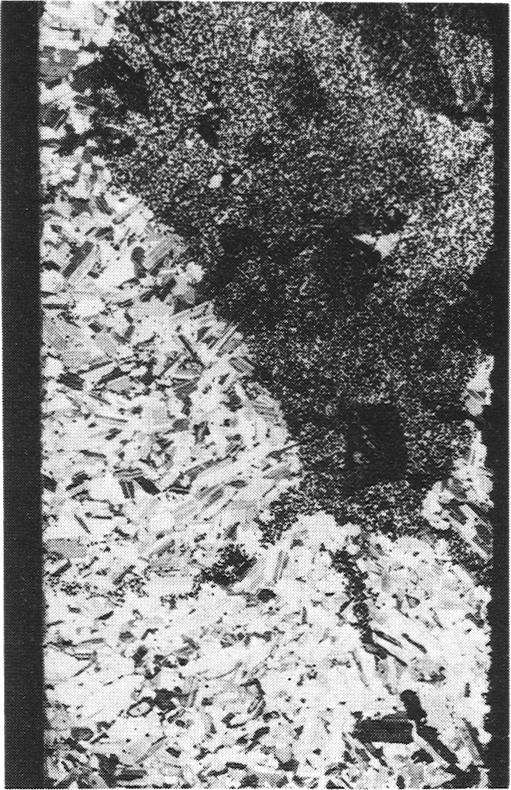 lb) to horizontally extensive embayments, up to 1 m deep and several metres across, which may be analogous to the pothole structures of the Bushveld complex (fig. ic).